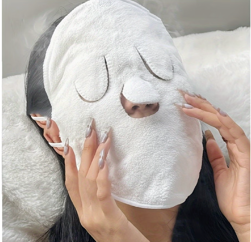 Close-up of hot cold compress face towel being applied to face